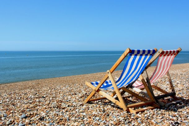 Deck chairs on stony beach